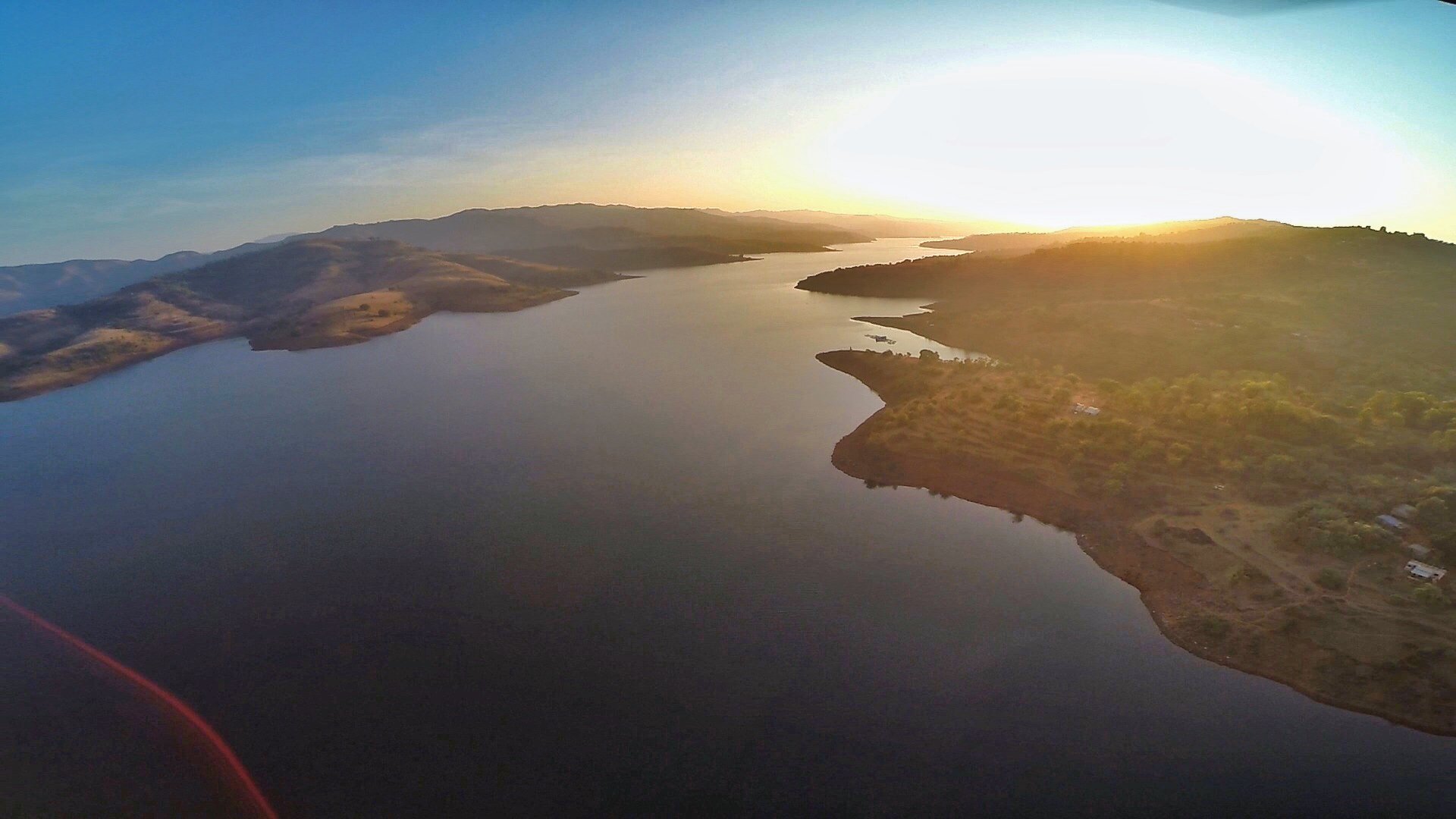 A lake holds the last light â€” from the drone. â€” Maharashtra