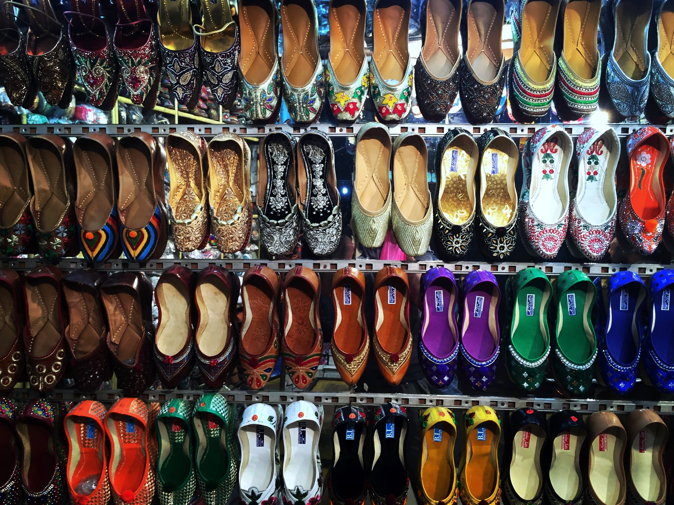Colours by the dozen â€” juttis strung up in the market. â€” Mumbai, Maharashtra Â· Nov 2015